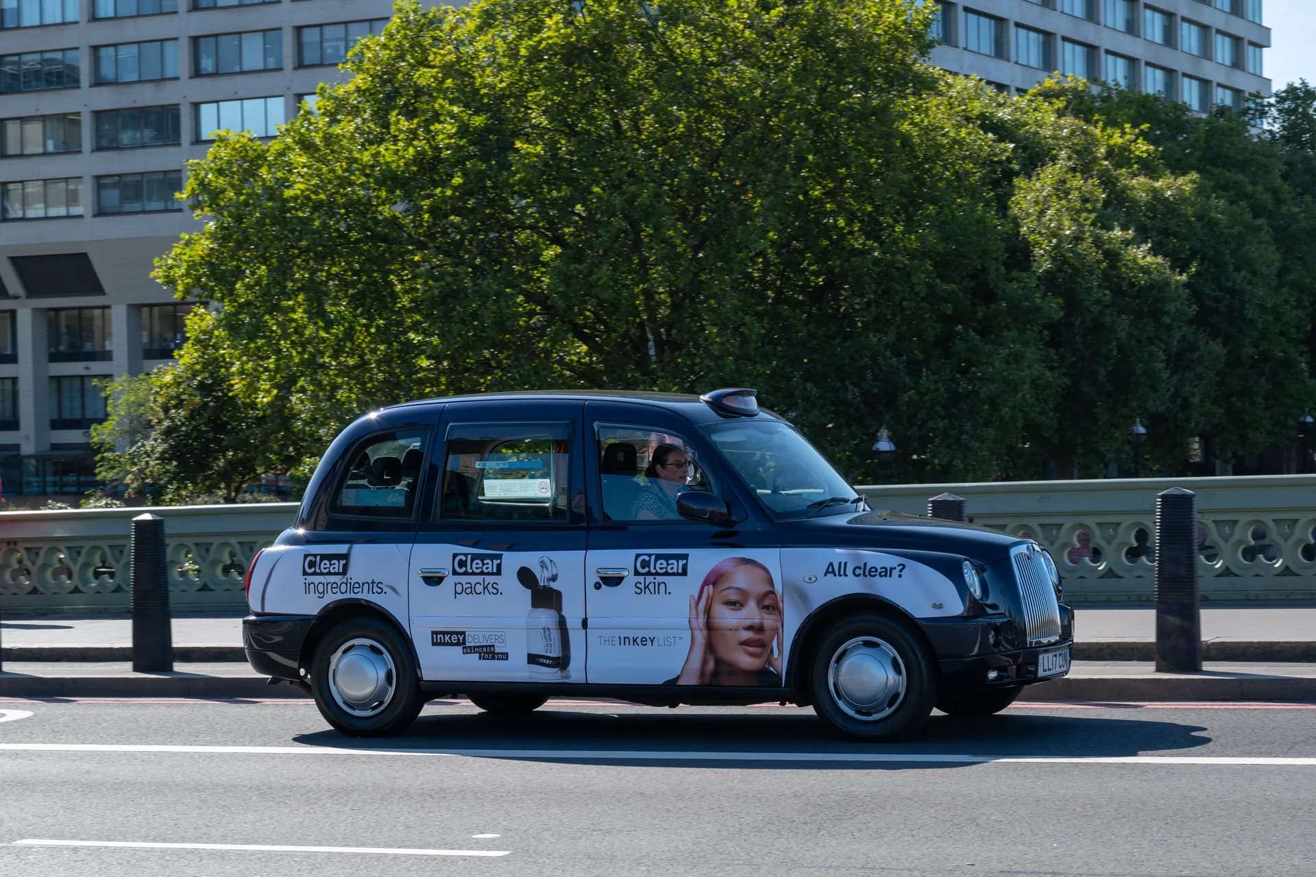 Black taxi with The Inkey List skincare advertising along its side